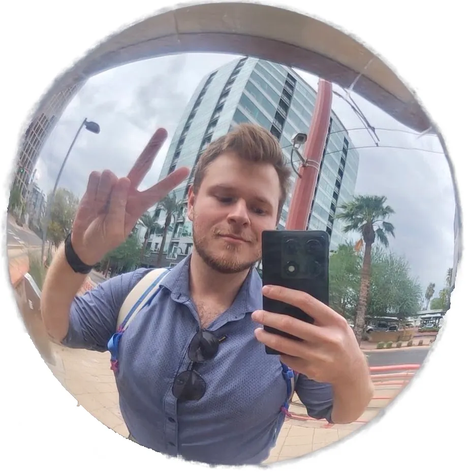 Bryce Terry taking a fisheye selfie on a city street, palm trees and an office tower behind him